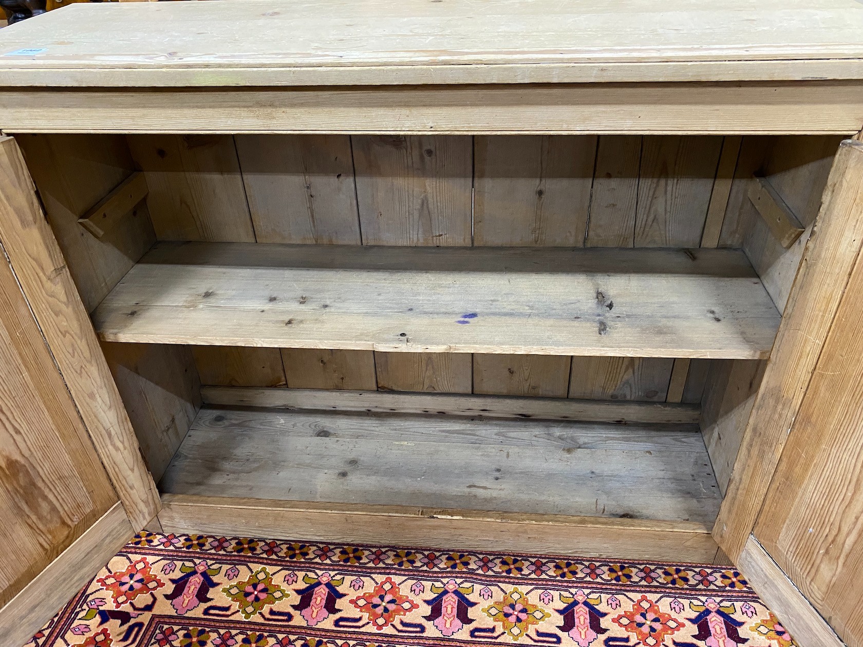 An Edwardian pine cupboard, width 126cm height 94cm